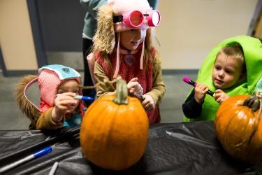 Attendees of NIC’s 2024 Career and Technical Education Trick or Treat Open House participate in a pumpkin decorating activity at NIC’s Parker Technical Education Center in Rathdrum.